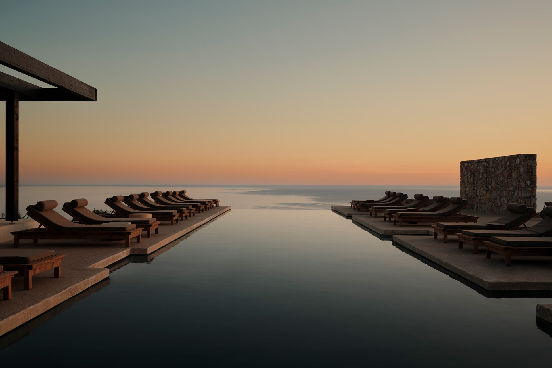 Gundari infinity pool overlooking the Aegean Sea at sunset